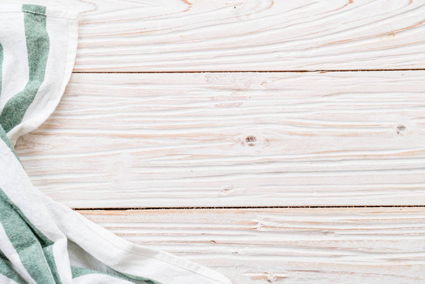 kitchen cloth (napkin) on wood background - Фото, изображение