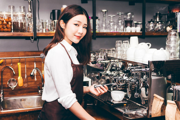 Women Barista using coffee machine for making coffee in the cafe - Photo, Image