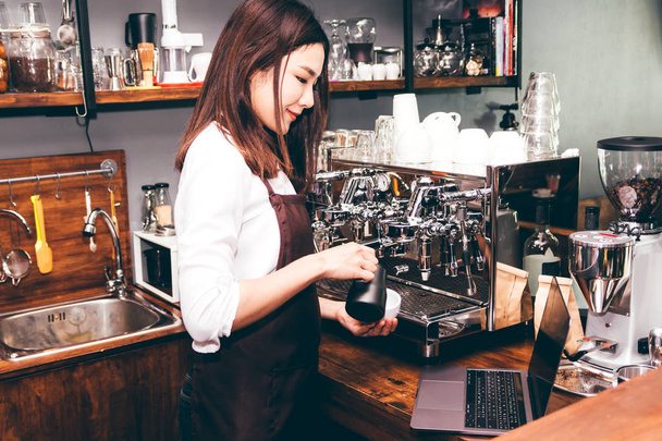 Barista houden van melk voor make koffie latte art in coffeeshop - Foto, afbeelding