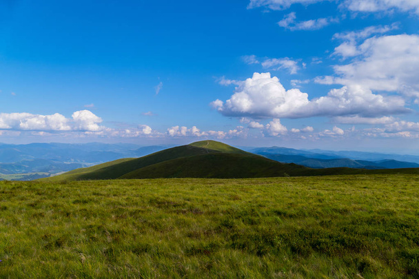 trampled path through the top of the mountain against the background of sky blue in the Carpathians - Photo, image