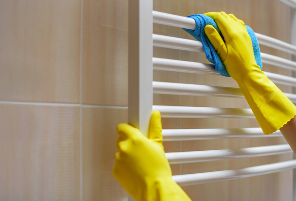 Female hands wash the radiator. - Zdjęcie, obraz