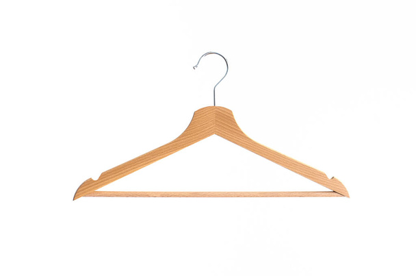 Wooden coat hanger isolated against bright white background - Photo, Image