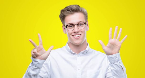 Young handsome blond man showing and pointing up with fingers number eight while smiling confident and happy. - Photo, Image