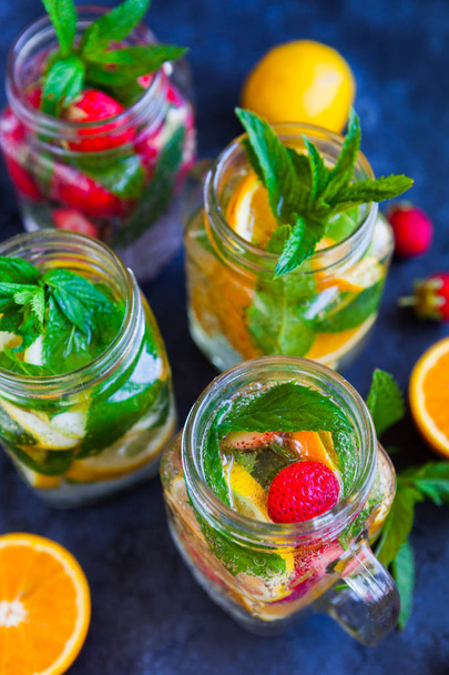 Fresh lemonade with summer fruits and berries on dark concrete background - Foto, imagen