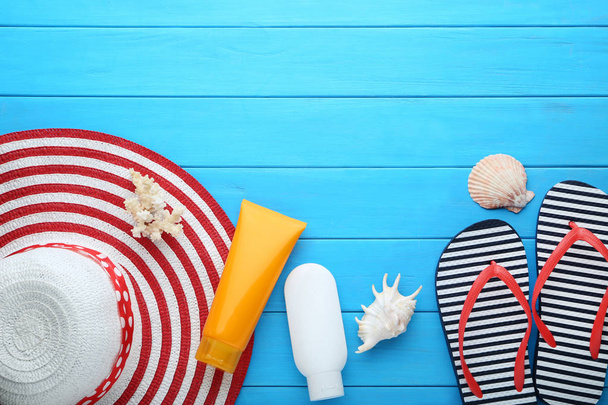 Summer accessories with seashells on blue wooden table - Fotografie, Obrázek