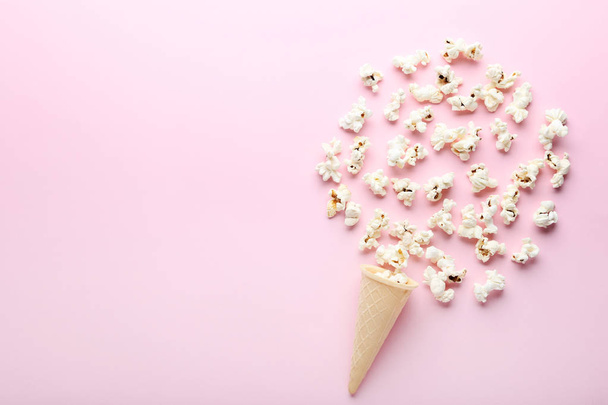Popcorn with waffle cone on pink background - Фото, зображення