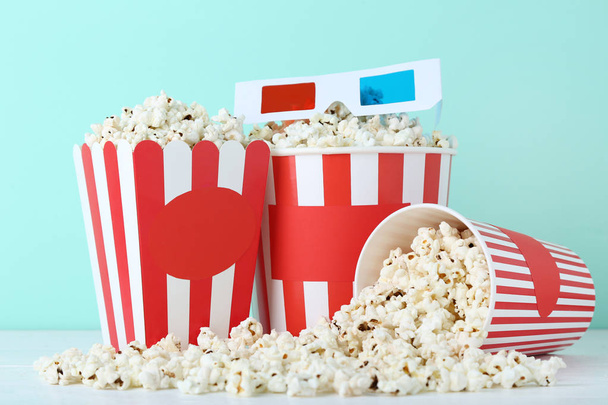 Popcorn in striped buckets with glasses on mint background - Valokuva, kuva