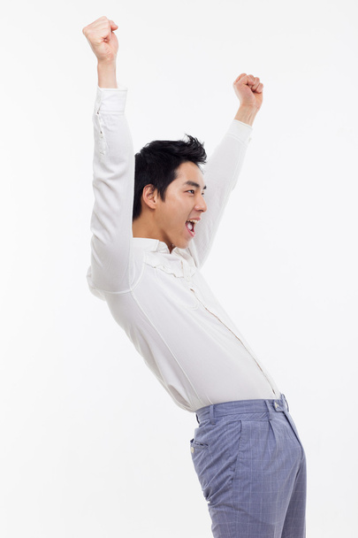 Young Asian man showing fist and happy sign. - Photo, Image