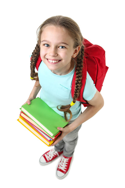 Young girl with backpack and books on white background - Fotografie, Obrázek