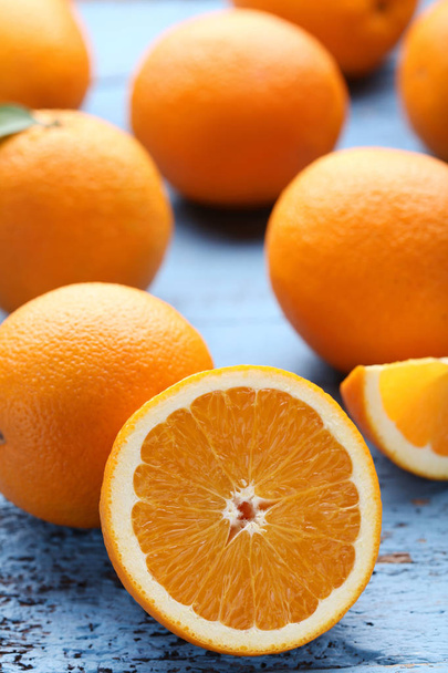 Orange fruit on blue wooden table - Foto, Imagen