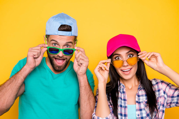 Head shot portrait of surprised glad students with unexpected unbelievable expression looking out eyewear with wide open mouth eyes isolated on vivid yellow background - Fotoğraf, Görsel