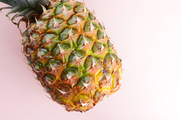 Pineapple on a pink background, tropical fruit top view, pineapple in pop art style, vegetarian food in minimalism style, copy space - Foto, afbeelding