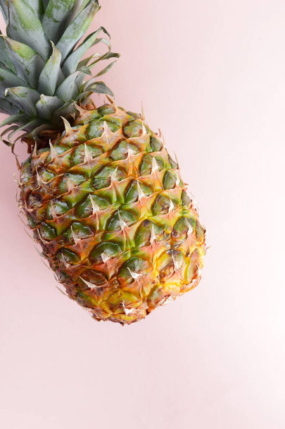 Pineapple on a pink background, tropical fruit top view, pineapple in pop art style, vegetarian food in minimalism style, copy space - Фото, зображення
