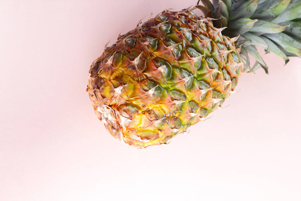 Pineapple on a pink background, tropical fruit top view, pineapple in pop art style, vegetarian food in minimalism style, copy space - 写真・画像