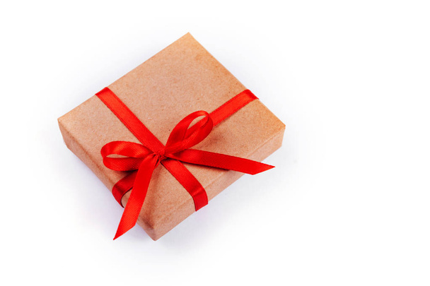 Present box with red bow on white background. Flat lay style. - Foto, Imagem