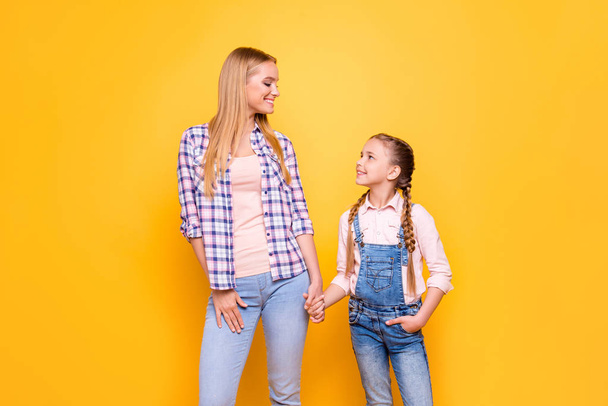 Siblings relatives aunt and niece cute hairstyle pigtails concept. Portrait of two kind supportive beautiful funny funky sweet cute lovely best friends looking at each other isolated vivid background - Photo, image