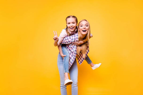 Mama mom older siblings game parenthood youth concept. Portrait of dreamy beautiful mommy holding carrying her excited cheerful cute sweet lovely girl on back isolated on bright vivid background - Fotoğraf, Görsel