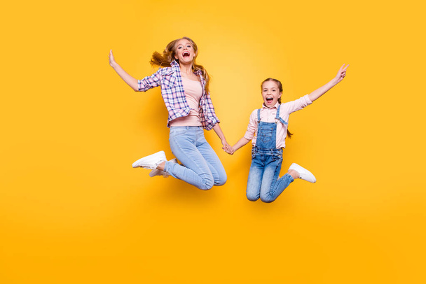 Mom mum mommy maternity two people best friendship upbringing rejoicing concept. Full length size portrait of cheerful joyful stylish modern relatives jumping up in air isolated on bright background - Zdjęcie, obraz