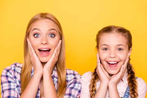 Wow like want! Blonde hair different age friendship concept. Close up portrait of two excited cheerful cute lovely charming girls holding palms near faces isolated on bright background - Photo, image