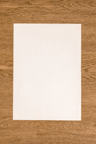 view from above of blank white paper on wooden table - Photo, Image