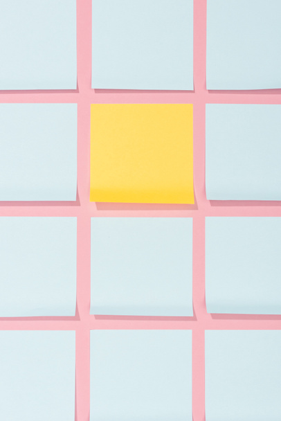 elevated view of empty blue and yellow stick it notes on pink  - Photo, Image