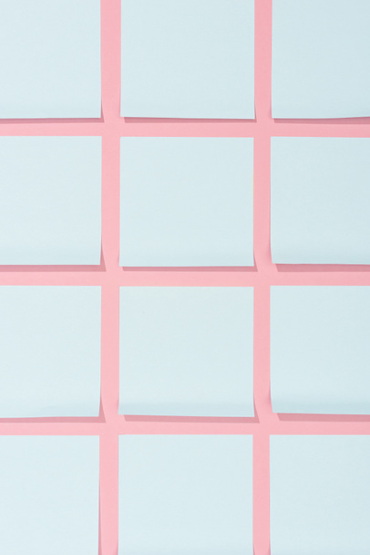 top view of set of blank blue stick it notes on pink - 写真・画像