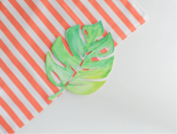 Summer concept background Unfocused aquarelle monstera leaf Stripes towel Copy space Top view Travel holiday card - Photo, Image