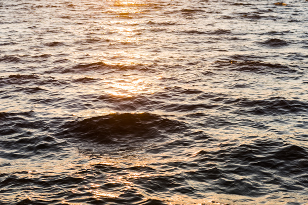 beautiful natural background with wavy sea at sunset - Fotoğraf, Görsel