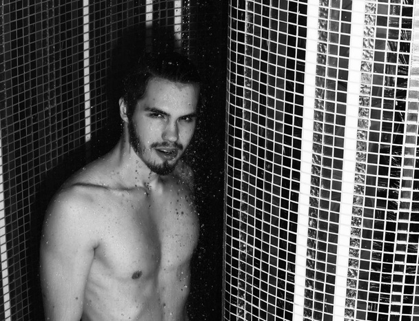 Handsome muscular sexy man washes in shower - Fotoğraf, Görsel