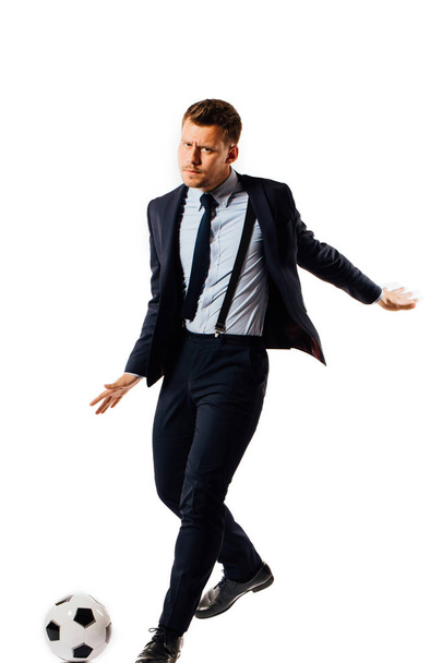 young handsome businessman manager kicking a soccer ball on white background isolated. - Valokuva, kuva
