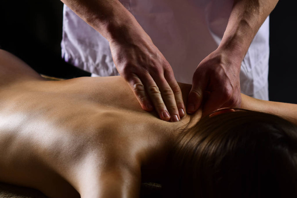spa massage. spa salon services. man make massage for woman in spa. spa therapy for naked girl. stress removing. - 写真・画像