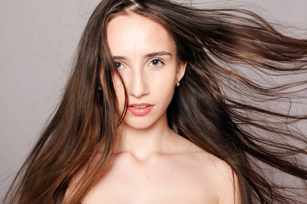 health, people and beauty concept - Model blonde girl. Beautiful brown hair Girl. Healthy Long Hair. Pretty spa model girl with perfect fresh clean skin. Youth and skin care concept - 写真・画像