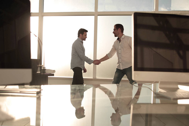 business background.modern office and a handshake of business partners - Foto, Bild