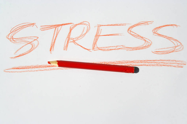 Red crayon and a stress note. Expressing stress syndrome with a note. - Photo, Image