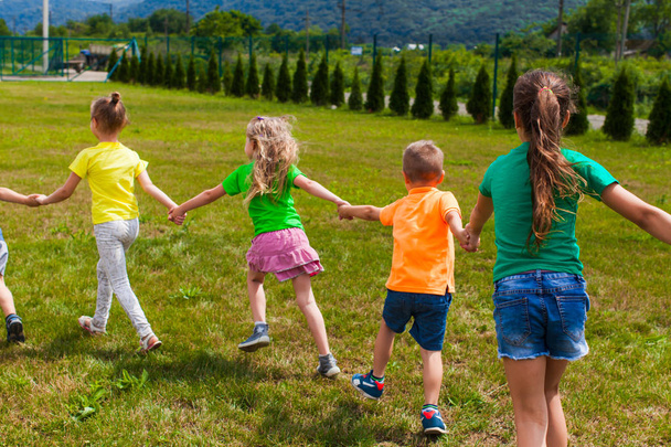 Group of children in colorful t-shirts on their holidays - Photo, Image