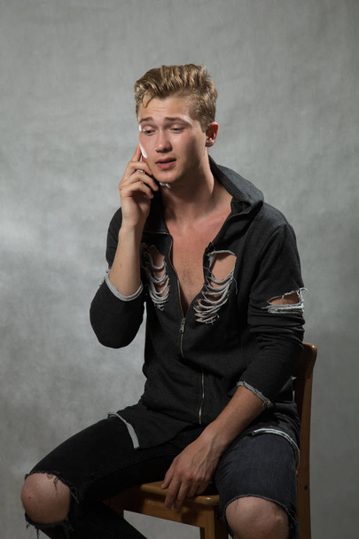 A shoot of young caucasian handsome blonde man against grey background. - Foto, Imagem