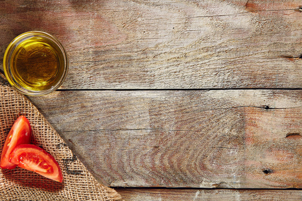 Sliced Tomatoes and Olive Oil on Wooden Rustic Background Top View with Place for Text. Old Wood Table Texture - 写真・画像