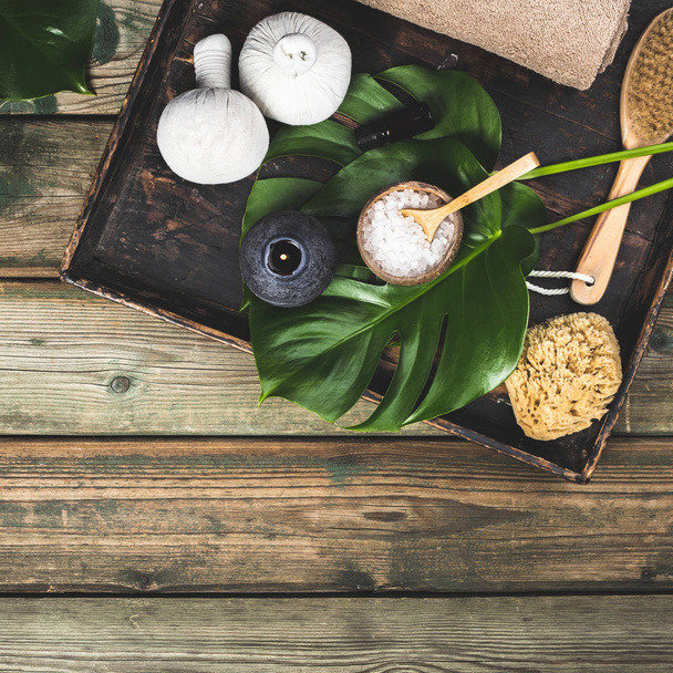 flat lay layout with monstera leaves and cosmetic care products - Foto, immagini