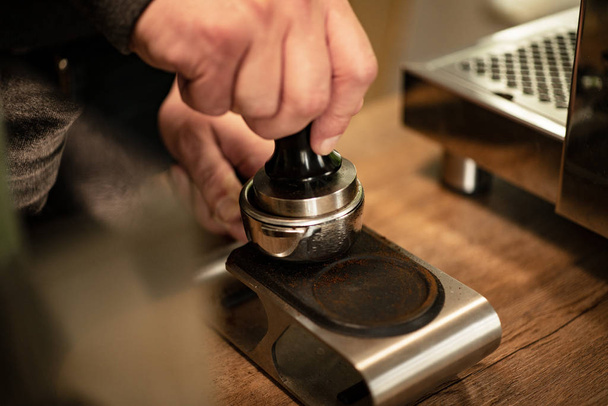 Man preparing portafilter for espresso shot at home. Professional equipment. - Zdjęcie, obraz