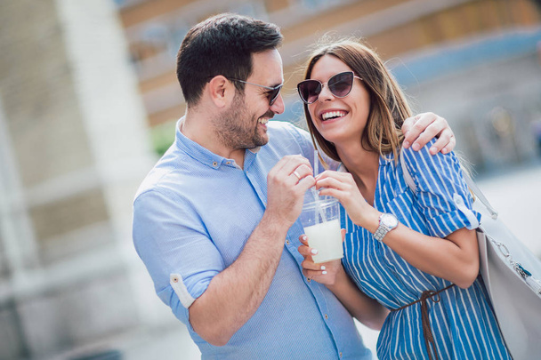 Young couple in love drinking juice, outdoor - Photo, Image