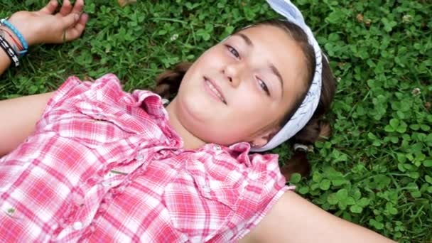 Top view beautiful young girl lying in the grass - Footage, Video