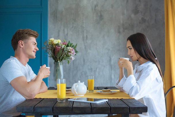 side view of young multicultural couple having breakfast together at home - Φωτογραφία, εικόνα