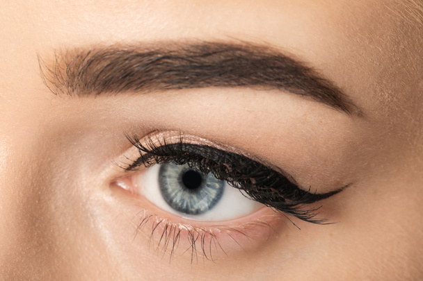 Eye of young woman with beautiful eyebrow after correction, closeup - Foto, imagen