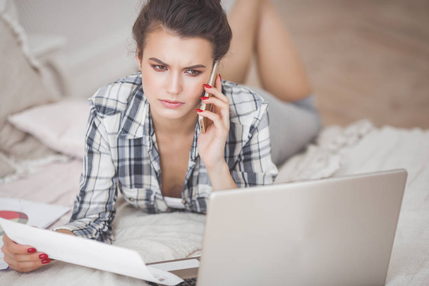 Young attractive woman working home at the laptop - Photo, Image