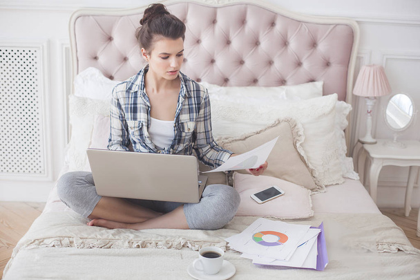 Young attractive woman working home at the laptop - Photo, Image