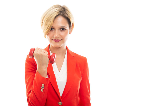 Young pretty business woman holding red dumbbell on white background with copyspace advertising area - Foto, Bild