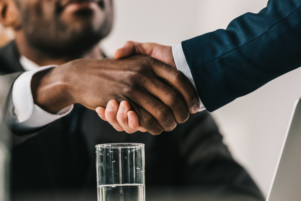 обрезанный снимок афро-американских бизнесменов, пожимающих руку
 - Фото, изображение