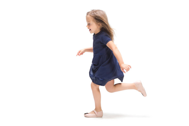 Smiling cute toddler girl three years running over white background - Valokuva, kuva