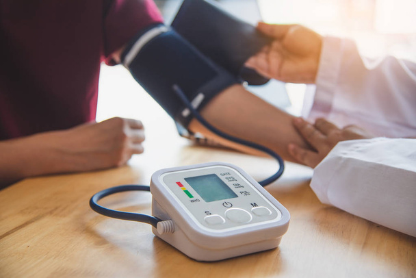 doctor measuring blood pressure from her patient - 写真・画像