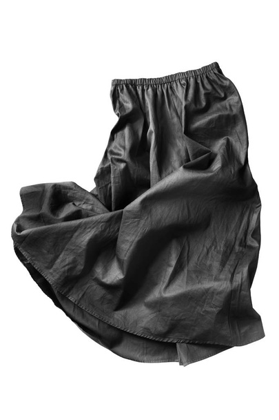 Black crumpled flared skirt on white background - Foto, afbeelding